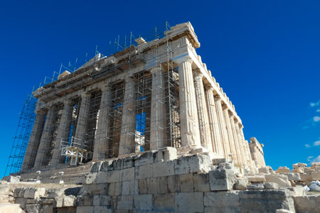 Tourists and guides visiting the parthenon on the acropolis of athens, greece, during restoration worksの写真素材