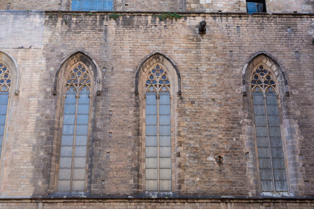 Architectural detail of the rose window and bell tower of Santa Maria del Pi, a 14th-century gothic church located in the heart of Barcelonaの写真素材