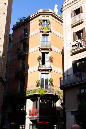 Flags with the Catalan flag hanging from balconies in a narrow street in the gothic quarter of Barcelona, Spainの写真素材