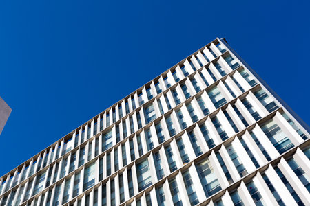 Modern building facade with repetitive architectural elements on a clear sunny day