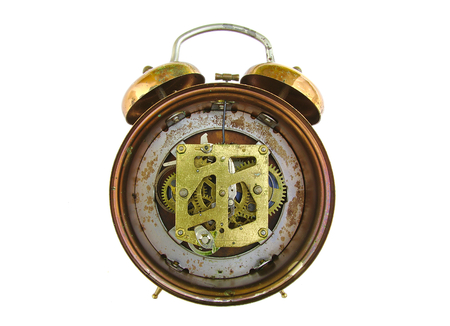 Inside mechanism of old alarm clock isolated on whiteの写真素材