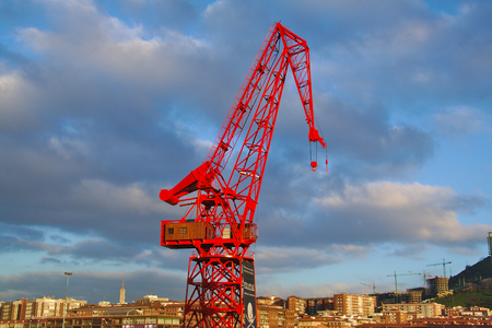 Front view of red crane, Carola, in Bilbao, Basque Contry, Spainの写真素材