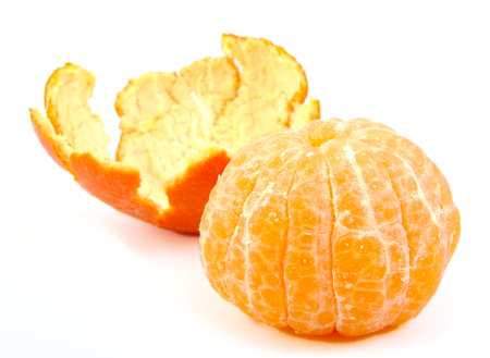 Peeled tangerine or mandarin fruit with its skin on white backgroundの写真素材