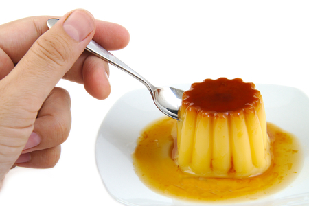 Closeup of creme caramel, caramel custard or custard pudding isolated on white backgroundの写真素材