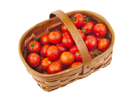 Fresh red cherry tomatoes in a basket isolated on white backgroundの写真素材