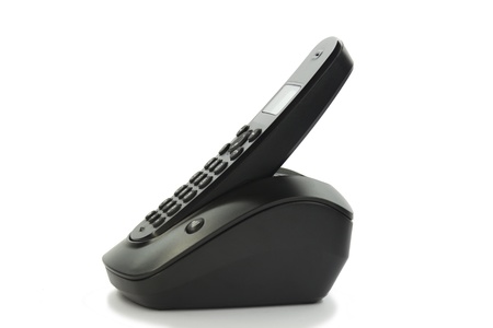 Black wireless phone resting on baseの写真素材