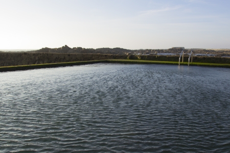 Swiming-pool with ocean water nexto to the sea.の写真素材