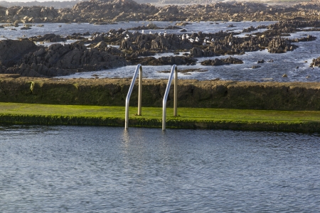 Swiming-pool with ocean water nexto to the sea.の写真素材