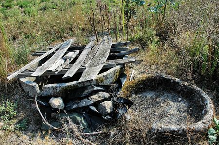 Abandoned well, in the midle of a fieldの写真素材