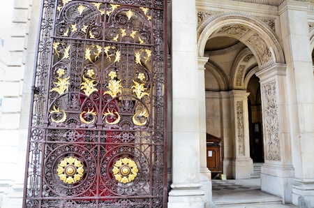Wrought iron gate richly decorated with gilded paintingsの写真素材
