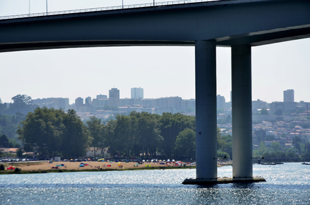 Modern bridge and beach on Douro riverの写真素材