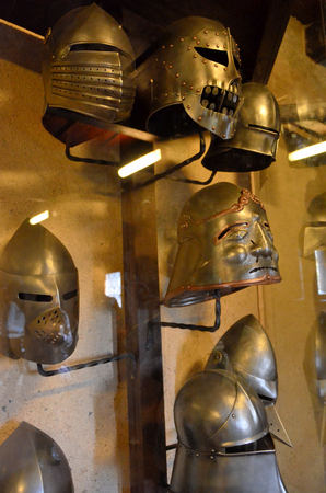 Medieval armor helmets on display in a museumの写真素材