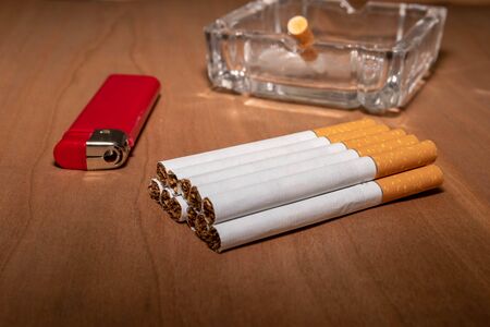 cigarette lighter red ashtray butt wooden background