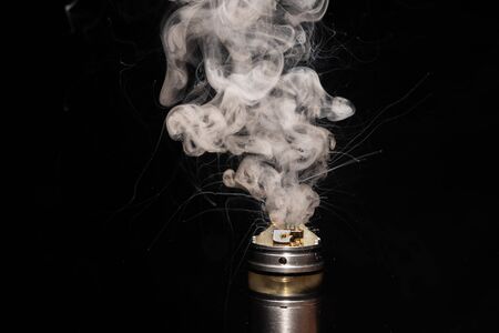lit electronic cigarette releasing smoke with black background