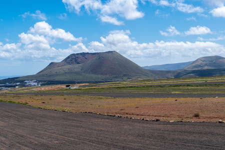 Volcano crater and lava field with vegetation in Lanzarote Canary Islands, Spain.