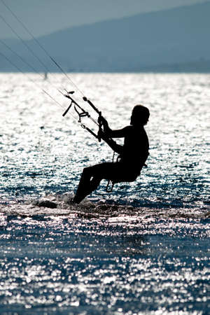 man doing kite surfing or kiteboarding