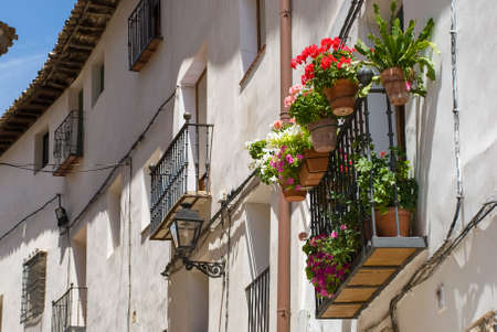 balcony decorated with flowers in a village in Spainの写真素材