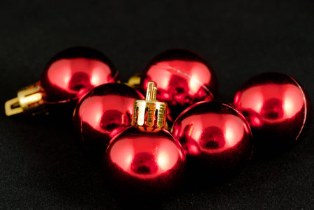 image of several red christmas balls on black backgroundの写真素材