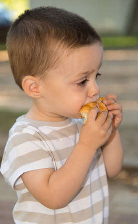 Portrait of a child eating a bunの写真素材