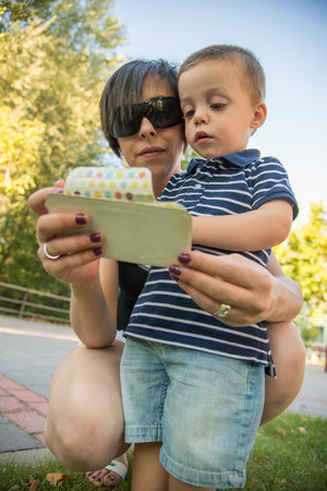a woman and a child with a smartphoneの写真素材