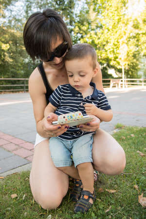 a woman and a child with a smartphoneの写真素材