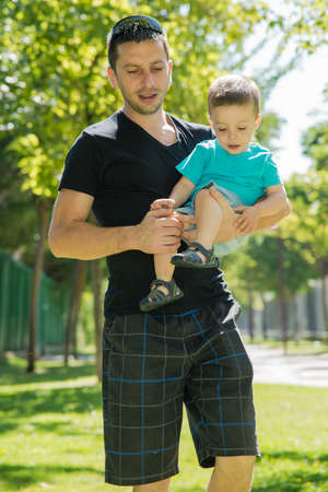 a man carrying a child in her armsの写真素材