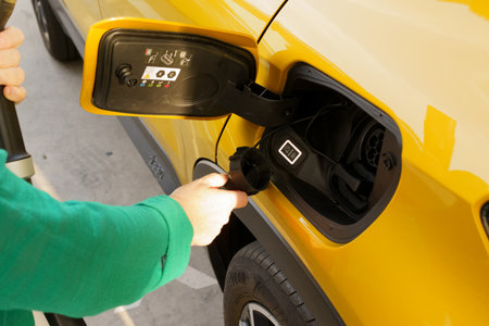 Electric car charging at a charging station, closeup of photoの写真素材