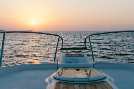 Picturesque view of sunset over calm sea from boat deck. の写真素材