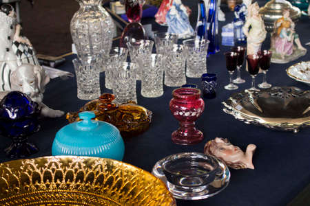 Crystal cups, glasses, plates, porcelain, pottery and other things displayed at a flea marketの写真素材