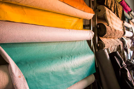 Colored fabrics suspended at an atelier's wallの写真素材