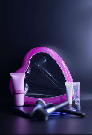 makeup kit with pink heart on dark backgroundの写真素材