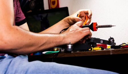 hands holding a welding device for repair electronic componentsの写真素材