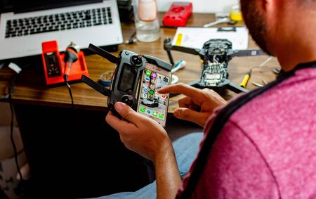 unrecognized guy holding remote control made with a cellphoneの写真素材