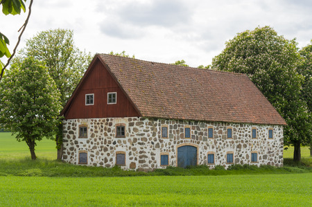 Old barn on a field in skaneの写真素材