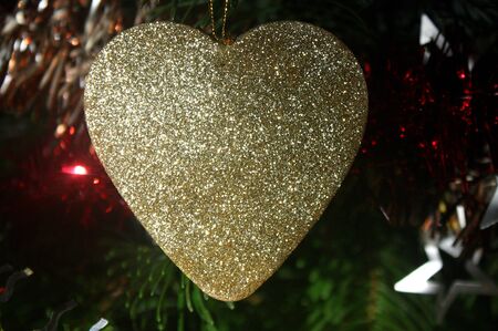 Sparkling heart on a Christmas treeの写真素材
