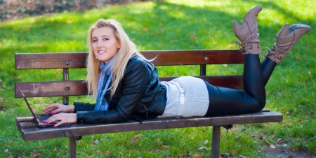 Girl With A Laptop In The Park Looking At The Cameraの写真素材