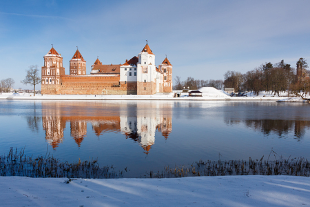 MIR, BELARUS - MARCH 20, 2016: Mir Castle in Minsk region is ancient heritage of Belarus reflected in lake. Winter scene with snow.のeditorial素材