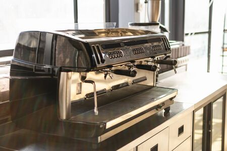 close up view of professional coffee machine on kitchen. sunny day, vintage color tones