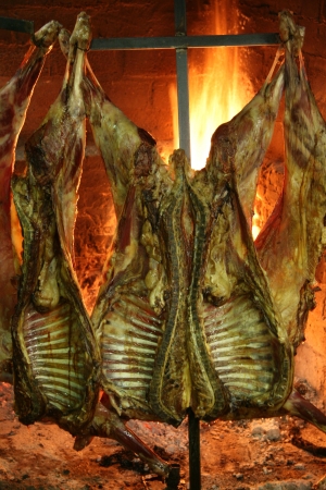 Sheep roasting near a fire in a typical Parilla restaurant in Patagonia. の写真素材