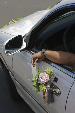 White limo window with driver's arm, doorhandle decorated with rose.の写真素材