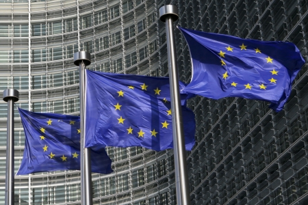 European flags waving in the wind, before the European Commission Berlaymont building in Brussels, Belgium European flags waving in the wind, before the European Commission Berlaymont building in Brussels, Belgium