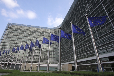 European flags waving in the wind, before the European Commission Berlaymont building in Brussels,...