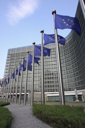 European flags waving in the wind, before the European Commission Berlaymont building in Brussels,...