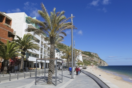 Unidentified people walking on the promenade near the beach and the Atlantic coast of Sesimbra, Portugal on May 27, 2013.のeditorial素材