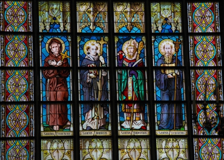 Stained glass window in a church of Leuven, Belgium, depicting Saint Francis, Saint Dominic, Saint Augustine and Saint Benedict  This window was created more than 100 years ago, no property release is required のeditorial素材