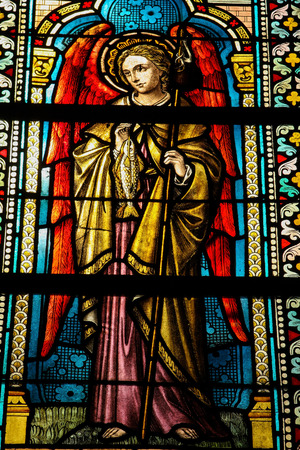 SPA, BELGIUM - JULY 19, 2009: Stained glass window depicting Saint Raphael in the cathedral of Spa, Wallonia, Belgium.のeditorial素材