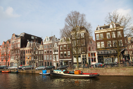 AMSTERDAM, THE NETHERLANDS - MARCH 25, 2011: View on a typical street near a canal in the center of Amsterdam, The Netherlands.のeditorial素材