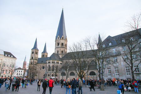 BONN, GERMANY - FEBRUARY 16, 2014:  Unidentified people in front of the Bonn Minster, or, in German, the Bonner MÃ¼nster, one of the oldest churches of Germany. It is located in Bonn, North Rhine Westphalia, Germany.のeditorial素材