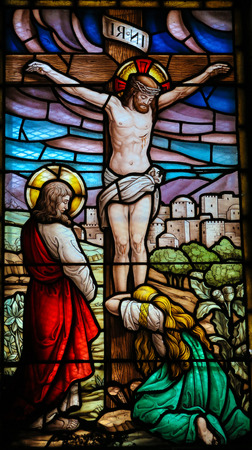 SAN ANDRES DE TEXEIDO, SPAIN - JULY 17, 2014: Stained glass window depicting the Crucifixion in the church of San Andres de Texeido, a famous Galician pilgrimage place in the Rias Altas region. This window was created more than 100 years ago, no property のeditorial素材