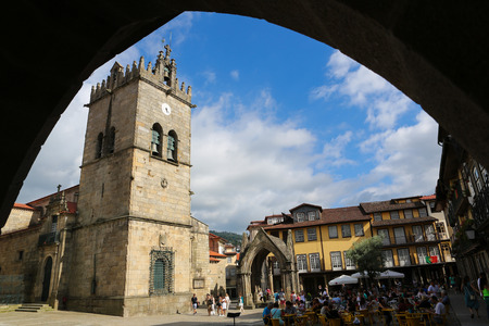 GUIMARAES, PORTUGAL - AUGUST 7, 2014: Oliveira Square with Nossa Senhora da Oliveira Church and Salado Monument in Guimaraes, Portugal.のeditorial素材
